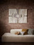 MODERNA TAPESTRY HUNG AGAINST WALLPAPER WITH SOFA AND NEEDLEPOINT CUSHIONS